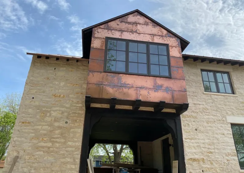 Copper metal panel facade on a stone building for Roof Repair in Pleasant Prairie